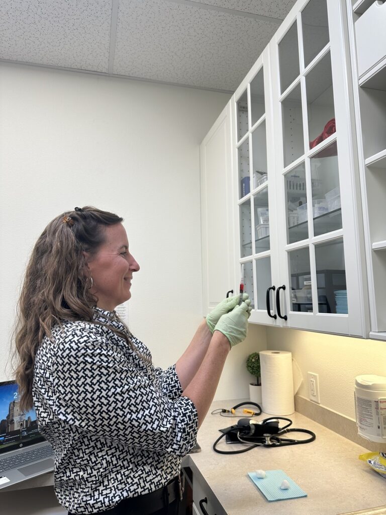 Doctor looks at sample and prepares for testing