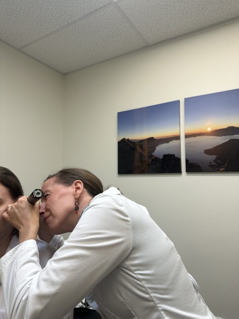 dr examines a patient's ear