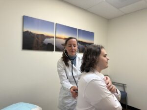 Doctor listens to patient's lungs