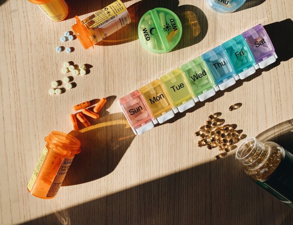 pill organizer and prescription bottles with pills and capsules