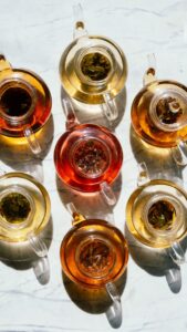 Assorted glass tea cups filled with herbal teas