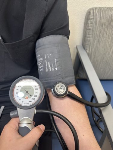 Patient having blood pressure checked