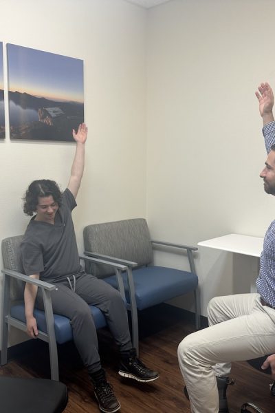 Doctor leads patient in a stretch